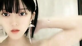 Sweet Asian teen tapes herself masturbating beside shower